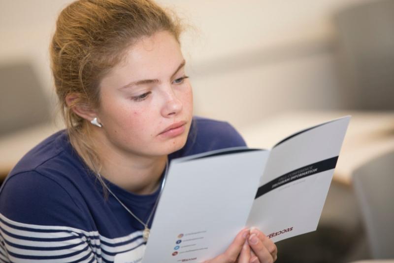 A female reading a leaflet