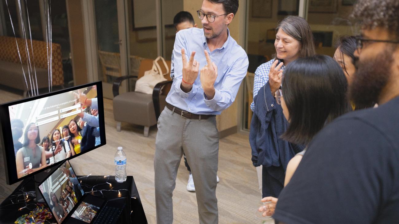 LDT student Brent Johnson shows guests how to interact with his project Quizeo.ai.