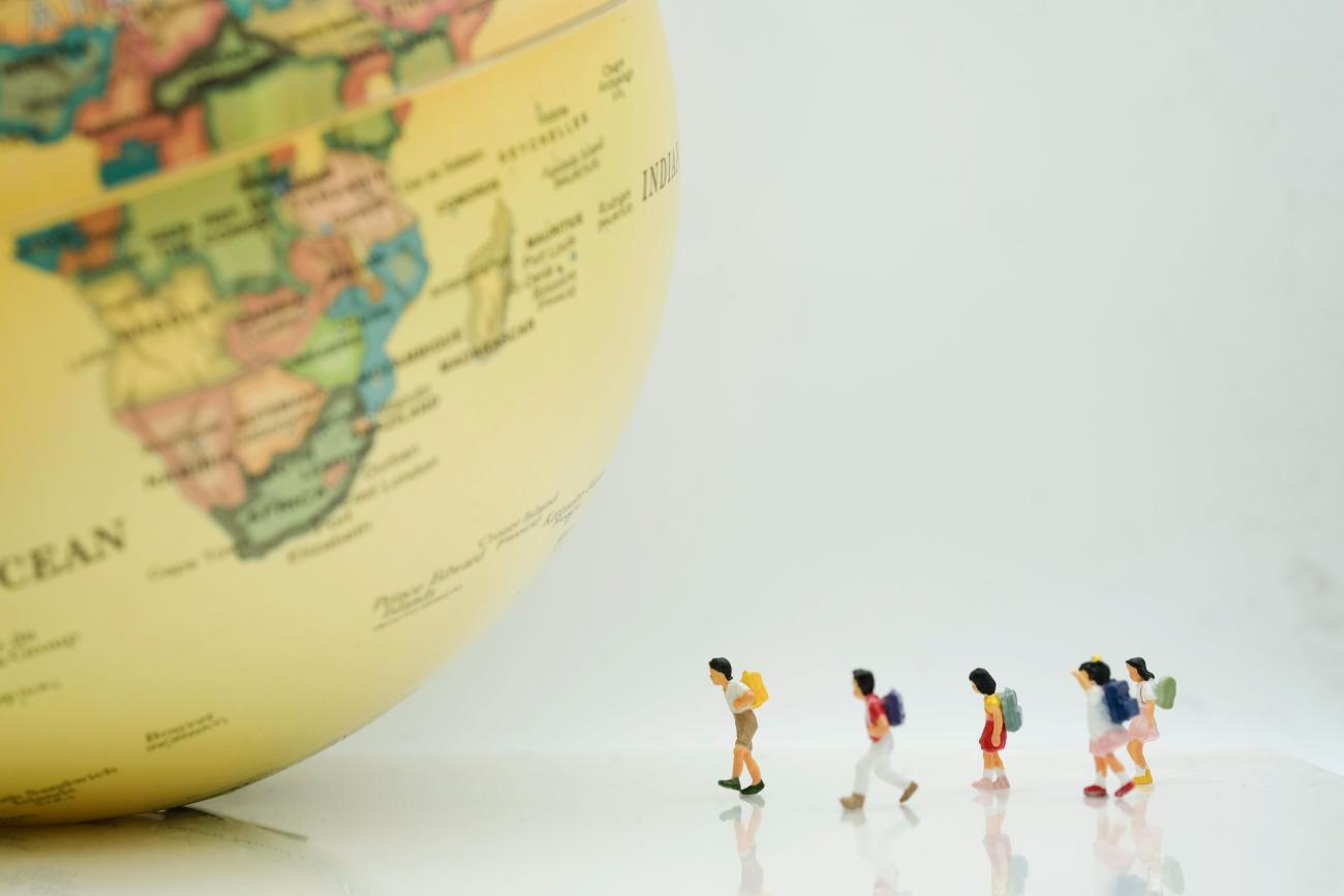 Image of schoolchildren approaching a globe