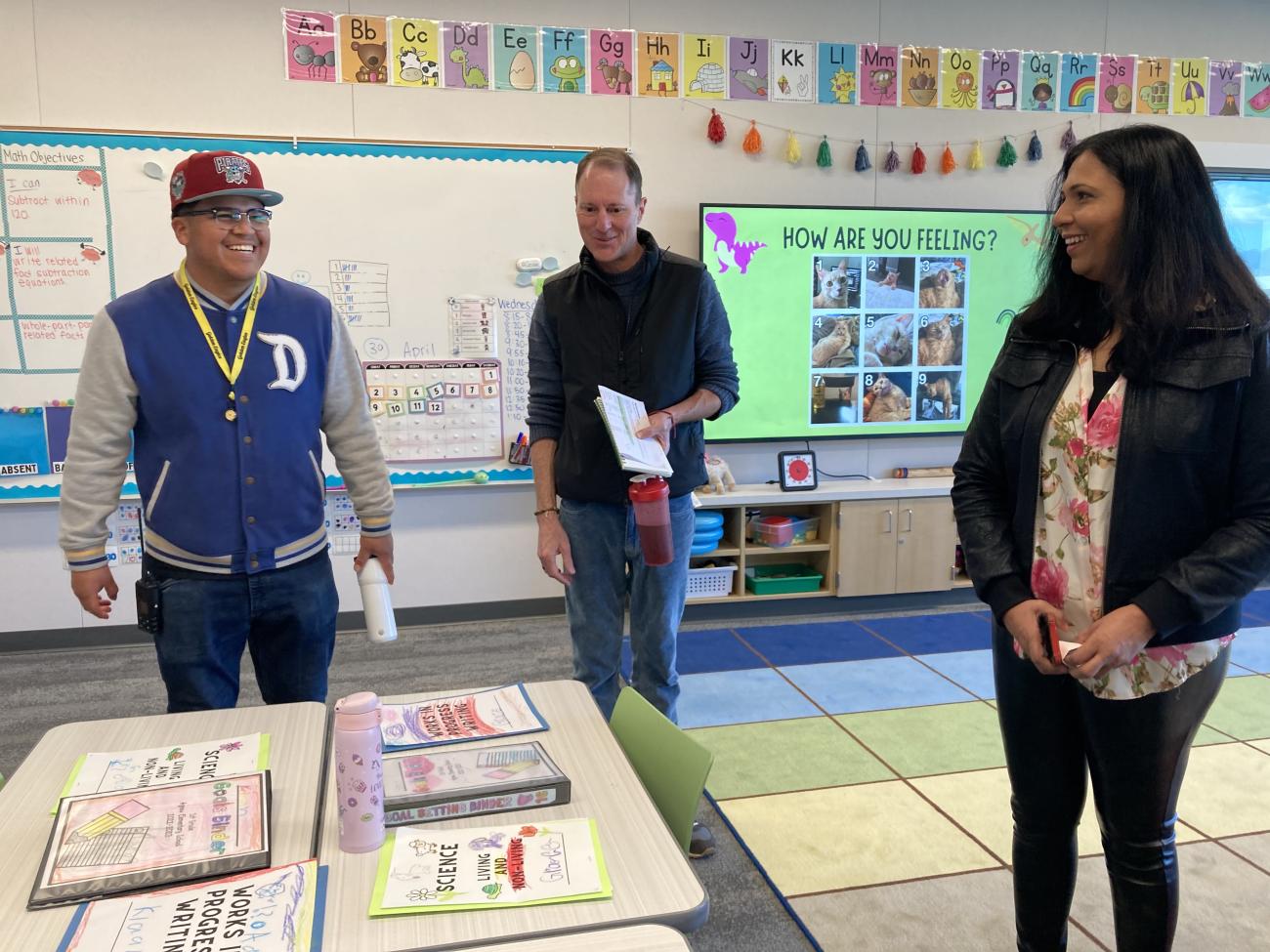 Jonny Hernandez, a paraeducator at Abram Agnew Elementary School, with GSE Associate Professor Chris Lemons and Stanford researcher Lakshmi Balasubramian. (Photo: Lisa Chung)