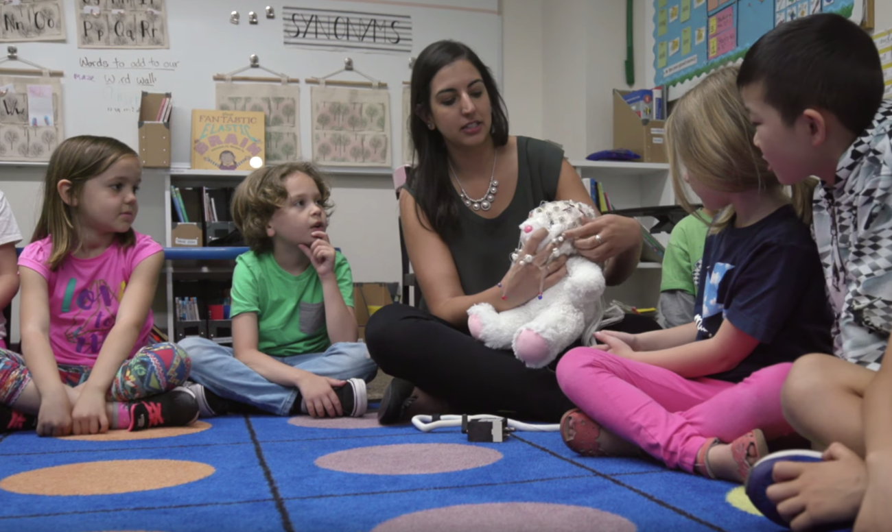 Picture of Elizabeth Toomarian teaching children about neuroscience with a stuffed bunny rabbit.
